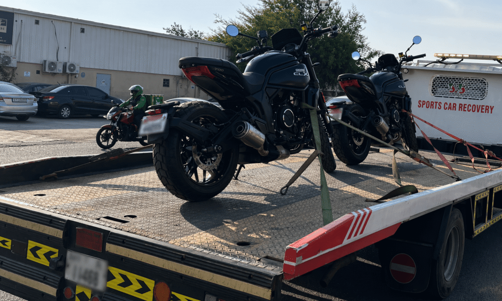 Tow truck with motorcycles on transport bed