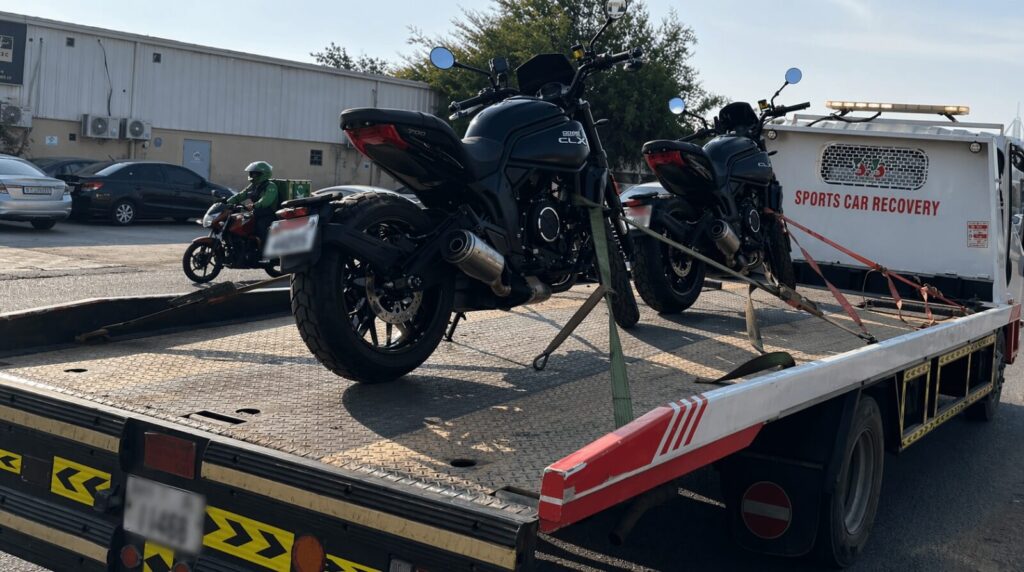 Tow truck with motorcycles on transport bed